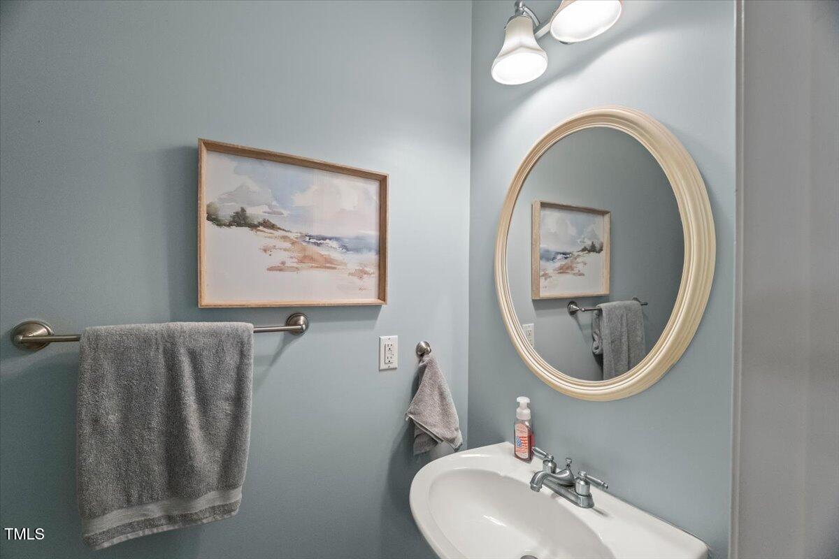 102 Barometer Lane Cary, NC 27513 - Photo 15 of 44 a bathroom with a toilet a sink and a mirror