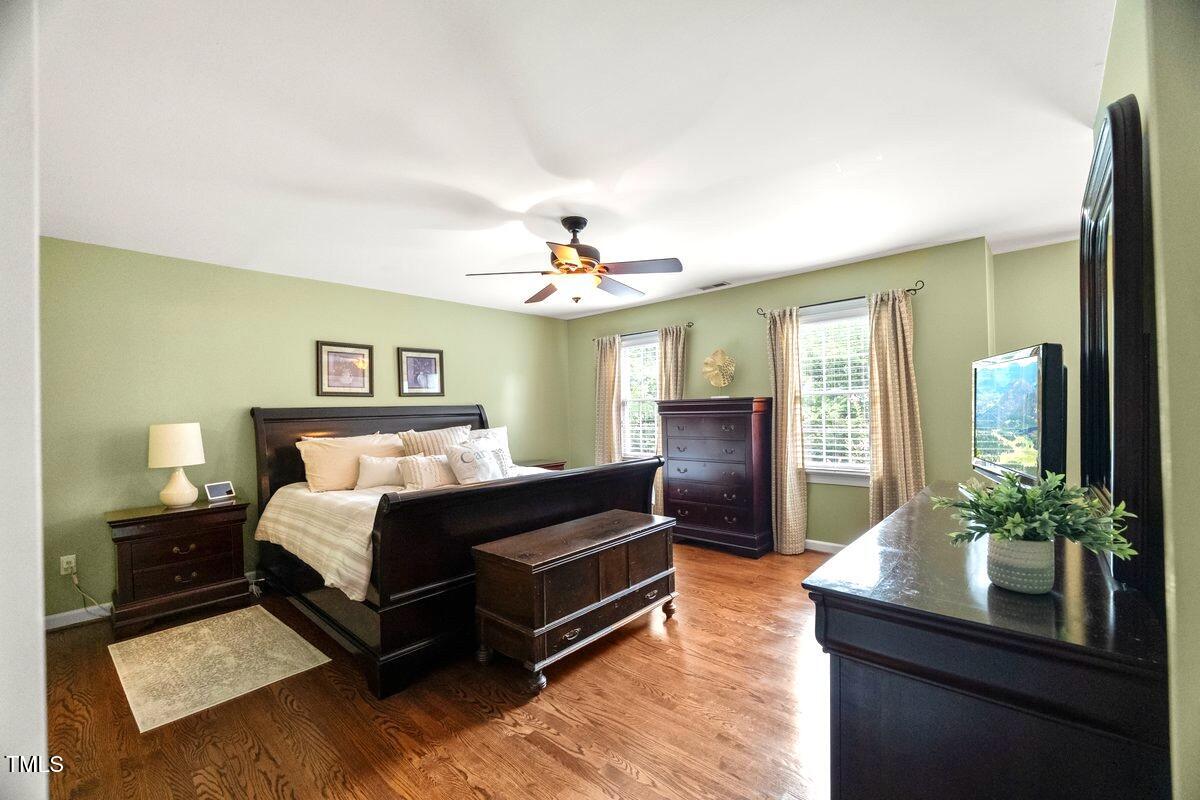 102 Barometer Lane Cary, NC 27513 - Photo 17 of 44 a bedroom with a bed and wooden floor