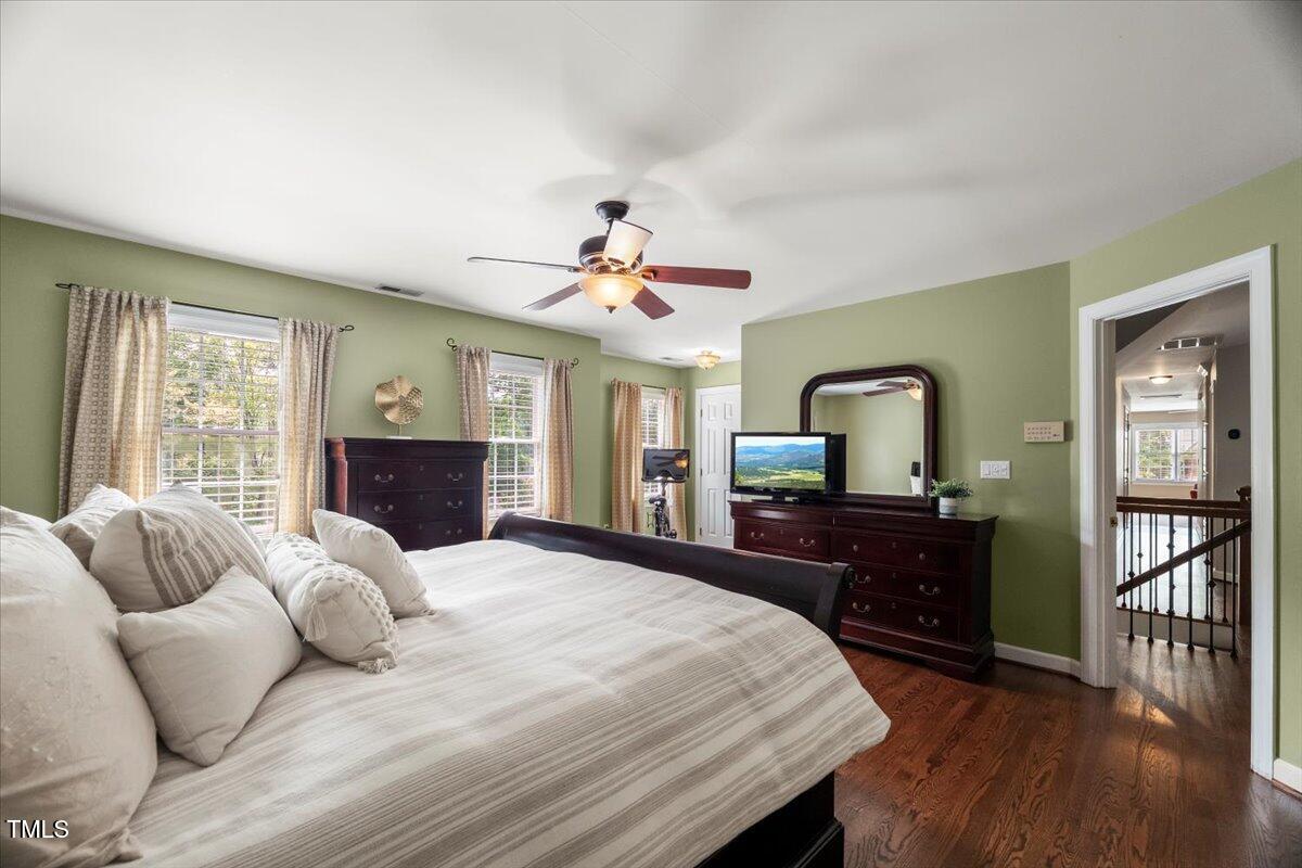 102 Barometer Lane Cary, NC 27513 - Photo 18 of 44 a bedroom with a bed dresser and wooden floor