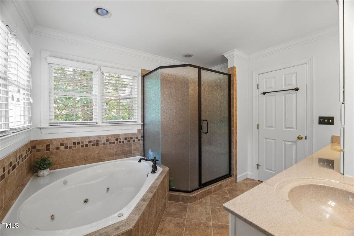 102 Barometer Lane Cary, NC 27513 - Photo 21 of 44 a bathroom with a tub a sink and a large window