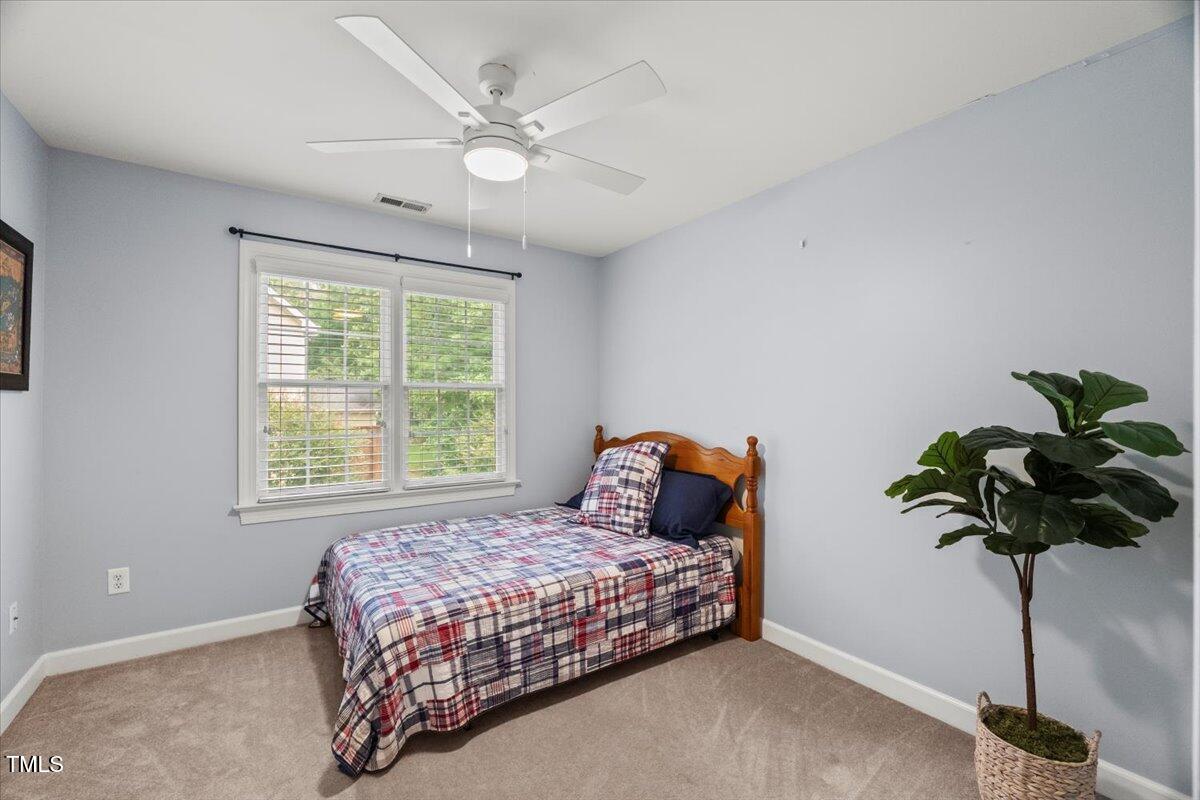 102 Barometer Lane Cary, NC 27513 - Photo 24 of 44 a bedroom with a bed and a potted plant