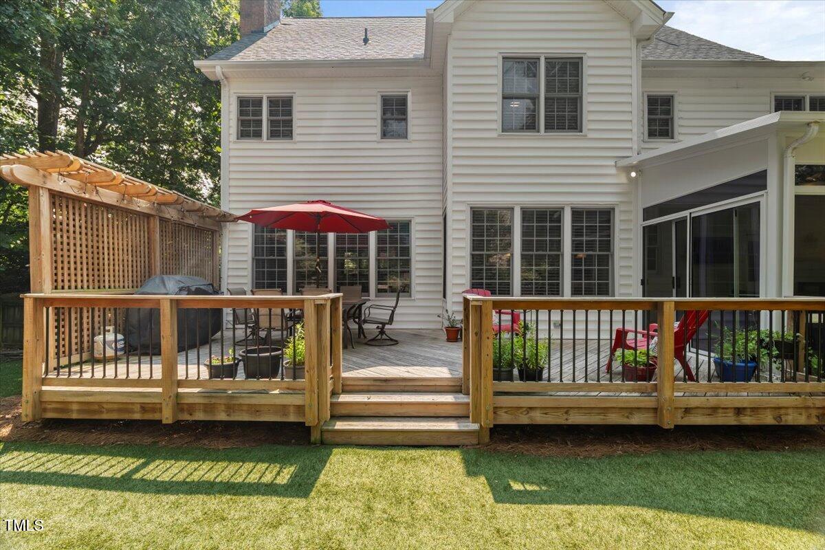 102 Barometer Lane Cary, NC 27513 - Photo 36 of 44 a view of a house with a wooden deck and a yard