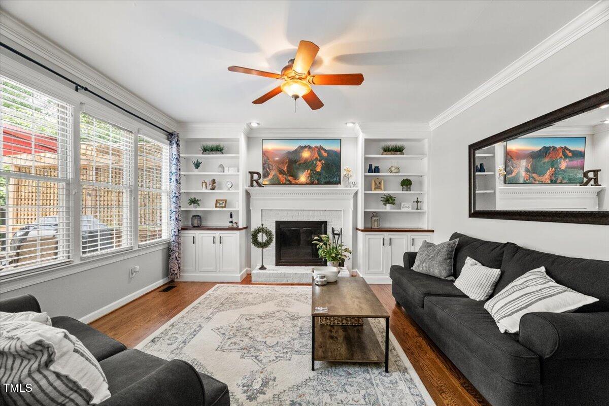 102 Barometer Lane Cary, NC 27513 - Photo 4 of 44 a living room with furniture a fireplace and a flat tv screen next to a window
