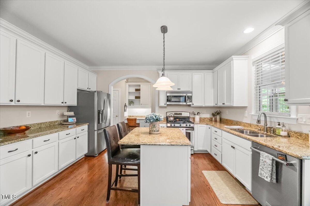 102 Barometer Lane Cary, NC 27513 - Photo 5 of 44 a kitchen with stainless steel appliances granite countertop a sink stove and refrigerator