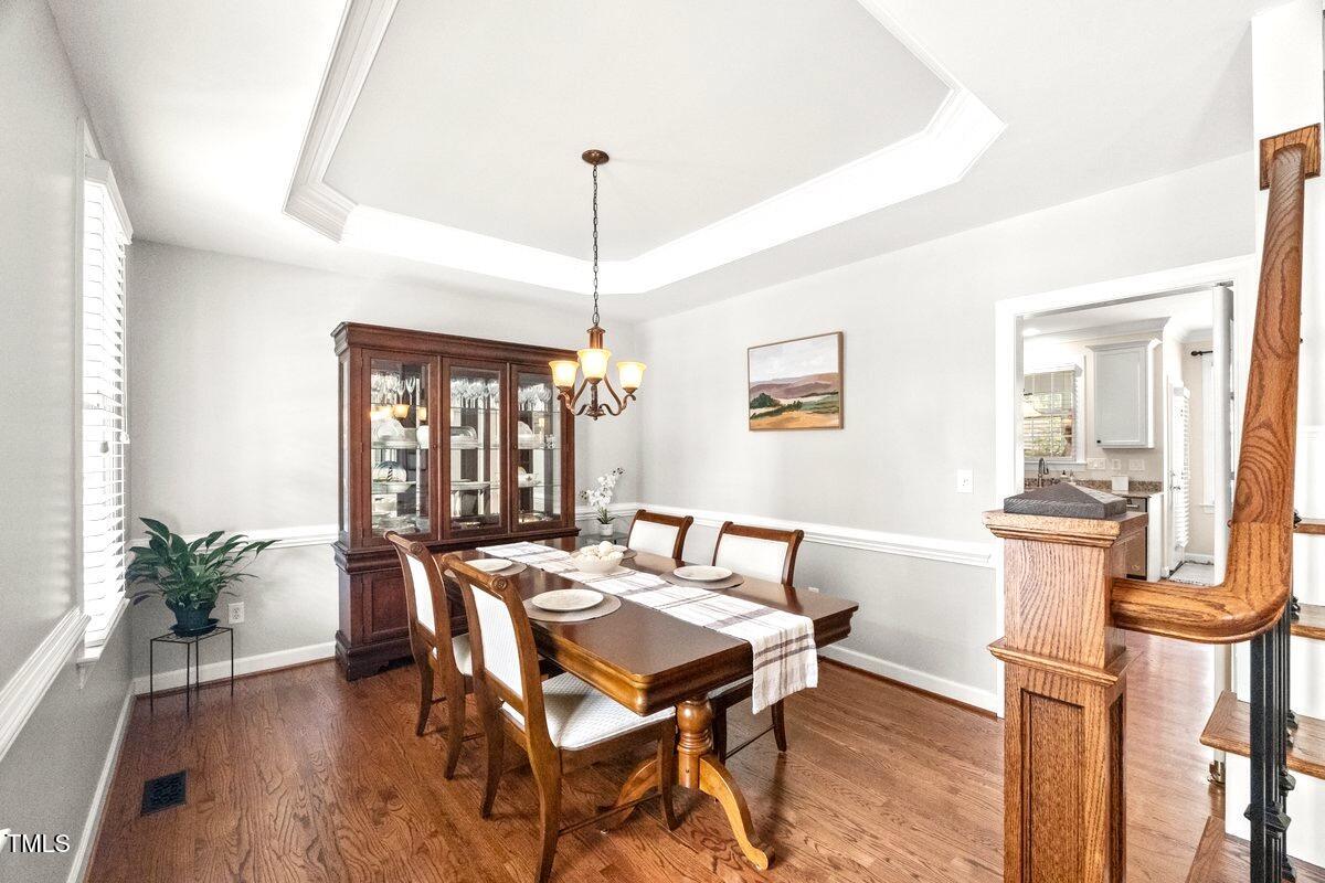 102 Barometer Lane Cary, NC 27513 - Photo 6 of 44 a dining room with furniture a chandelier and wooden floor