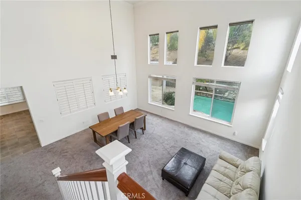 a living room with furniture and floor to ceiling windows