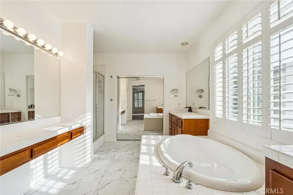 a spacious bathroom with sink shower and bathtub