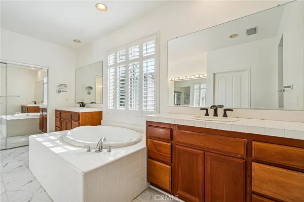 a large white kitchen with a large window
