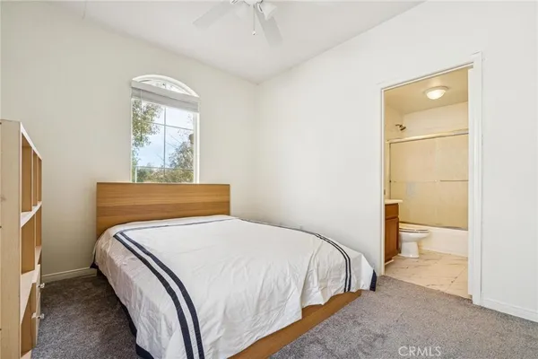 a bedroom with a bed and a window