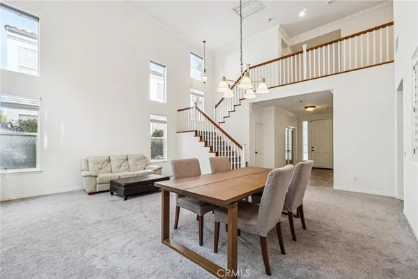 a dining room with furniture and entryway