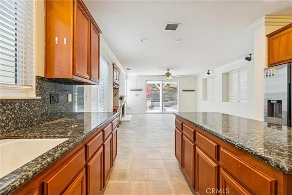 a kitchen with granite countertop sink and cabinets