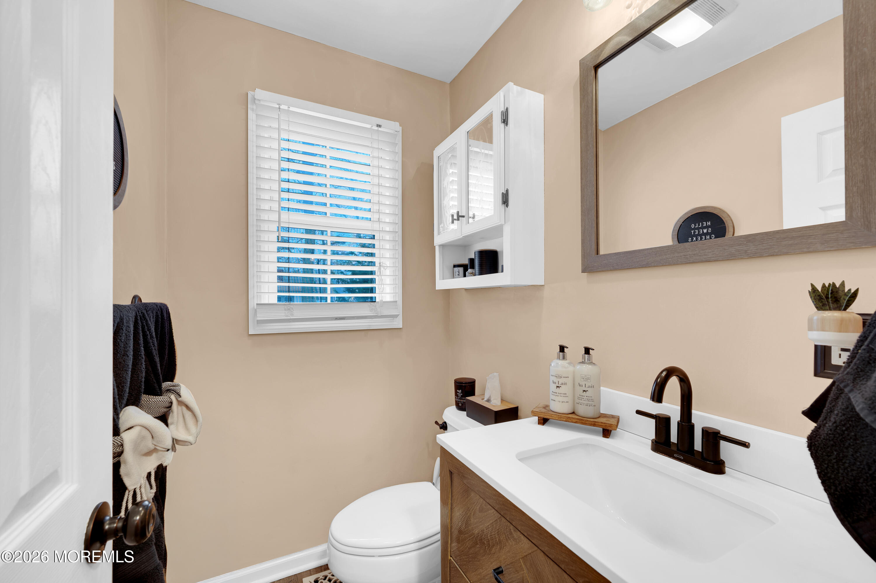 321 Letts Avenue Forked River, NJ 08731 - Photo 11 of 38 a bathroom with a sink a toilet and a mirror