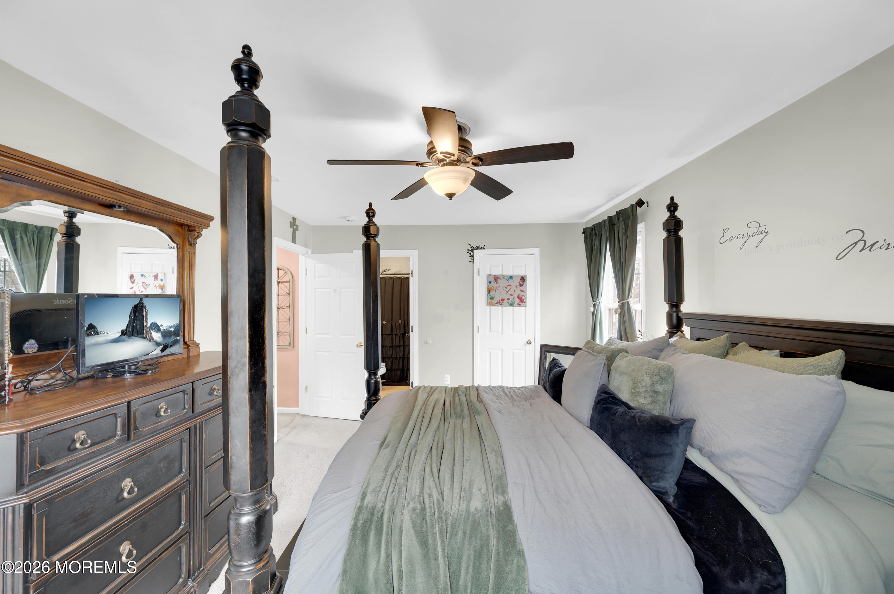 321 Letts Avenue Forked River, NJ 08731 - Photo 13 of 38 a bedroom with a bed and a chandelier