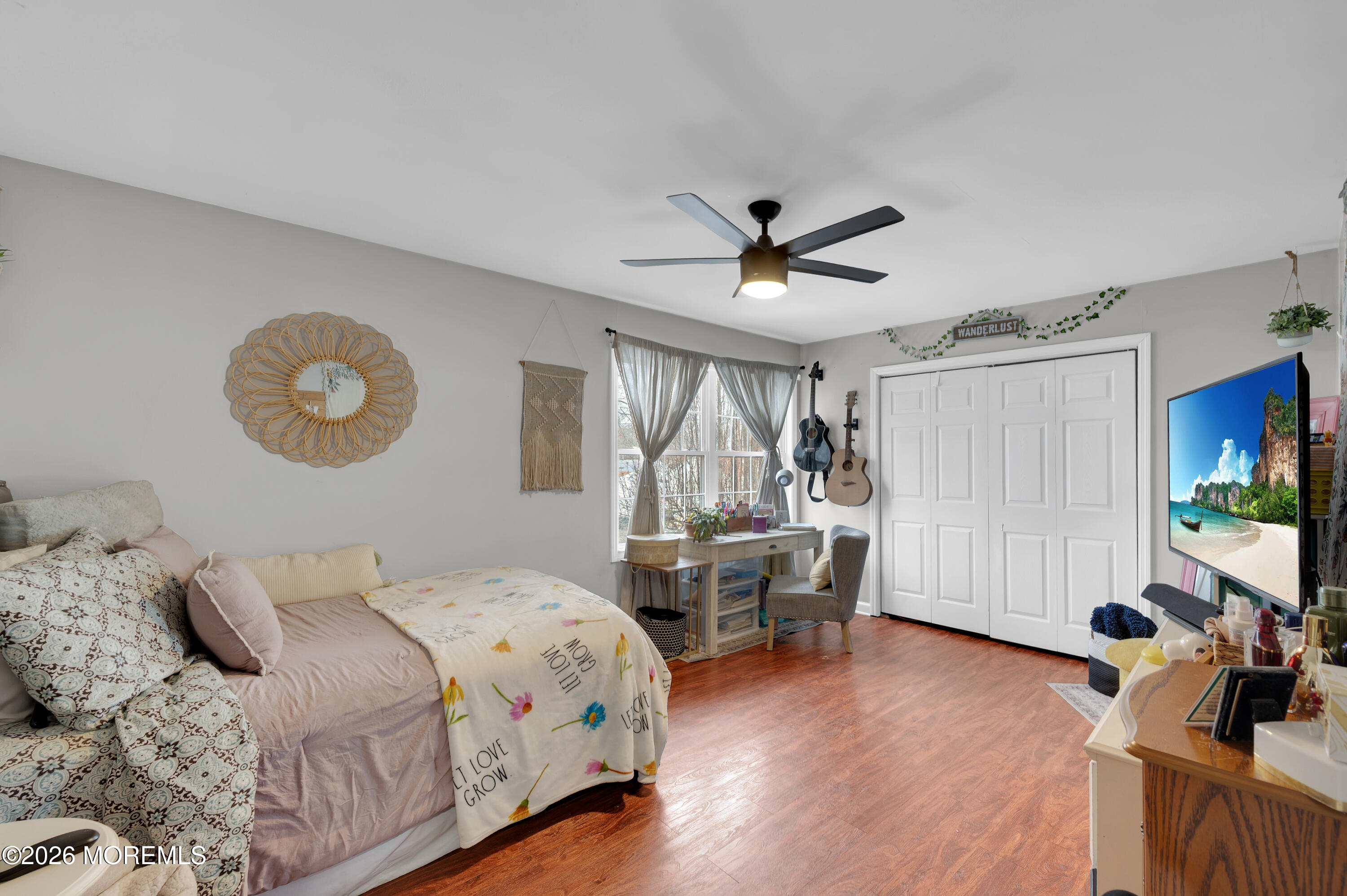 321 Letts Avenue Forked River, NJ 08731 - Photo 15 of 38 a spacious bedroom with a bed a dresser and a flat screen tv