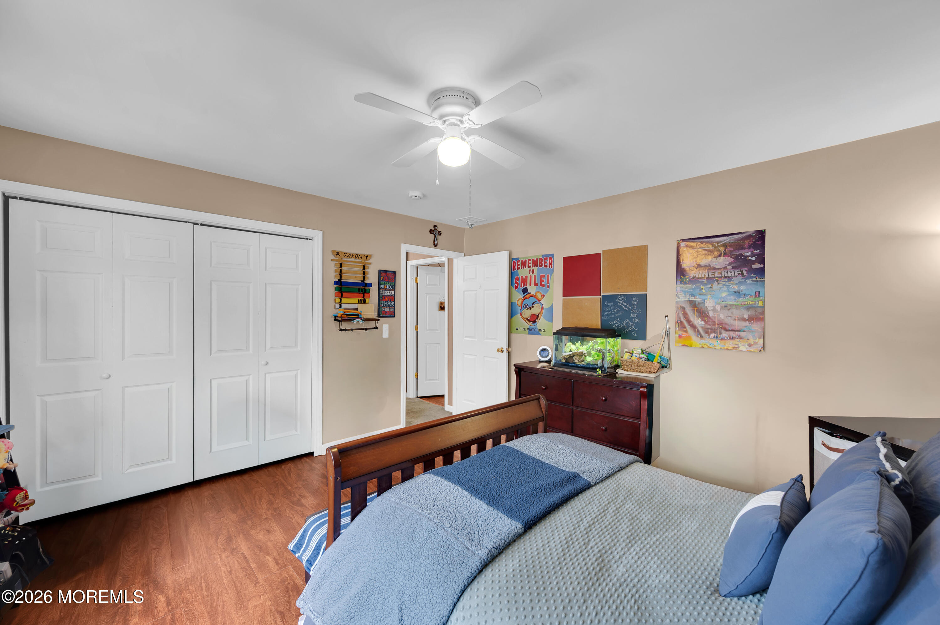 321 Letts Avenue Forked River, NJ 08731 - Photo 17 of 38 a bedroom with a bed and a chandelier