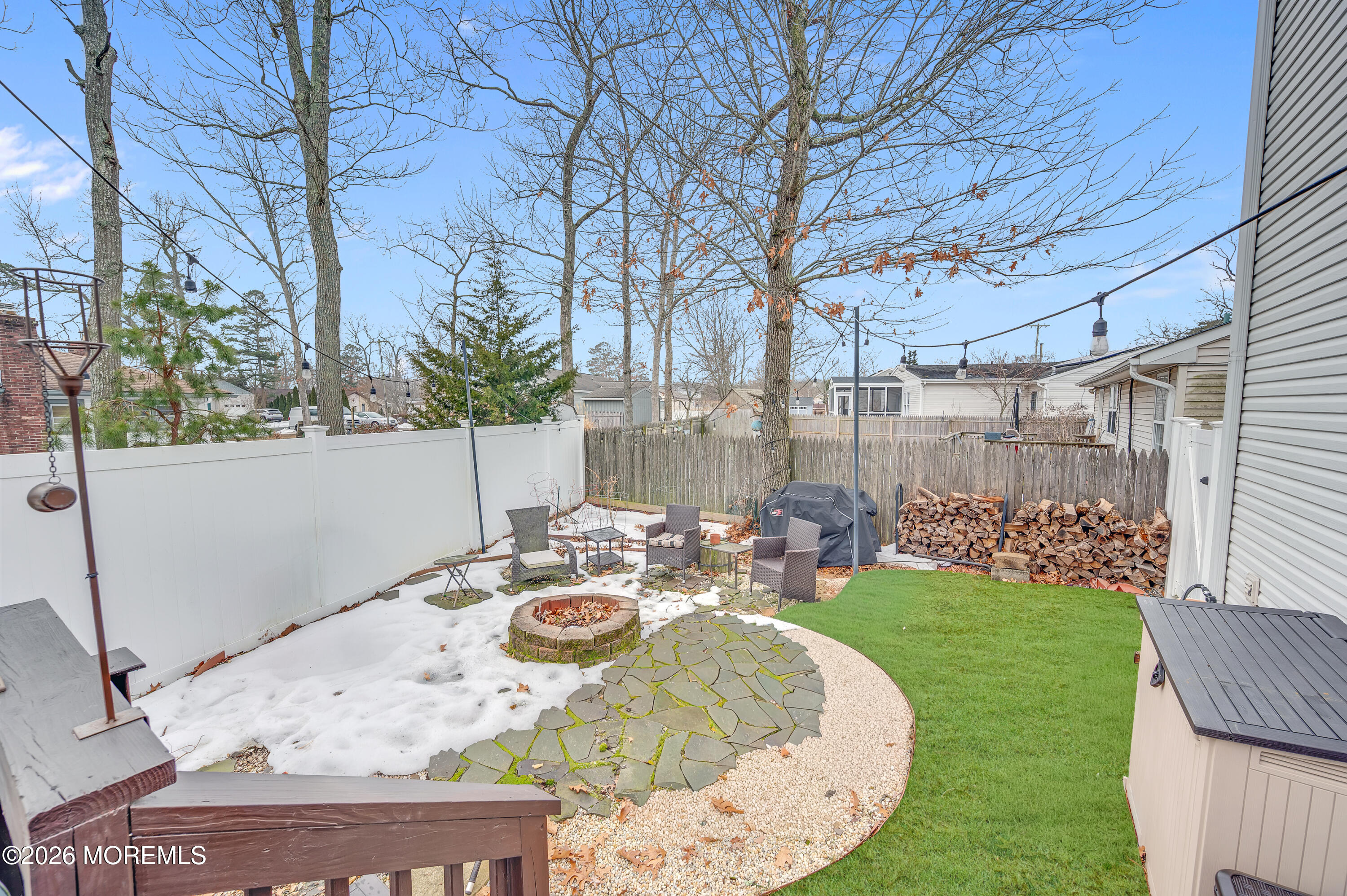 321 Letts Avenue Forked River, NJ 08731 - Photo 23 of 38 a view of a patio with table and chairs potted plants and large tree