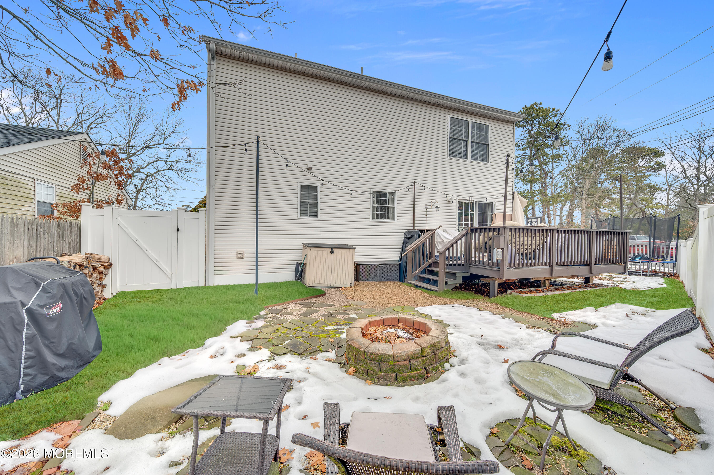 321 Letts Avenue Forked River, NJ 08731 - Photo 24 of 38 a view of a backyard with table and chairs potted plants and a fire pit
