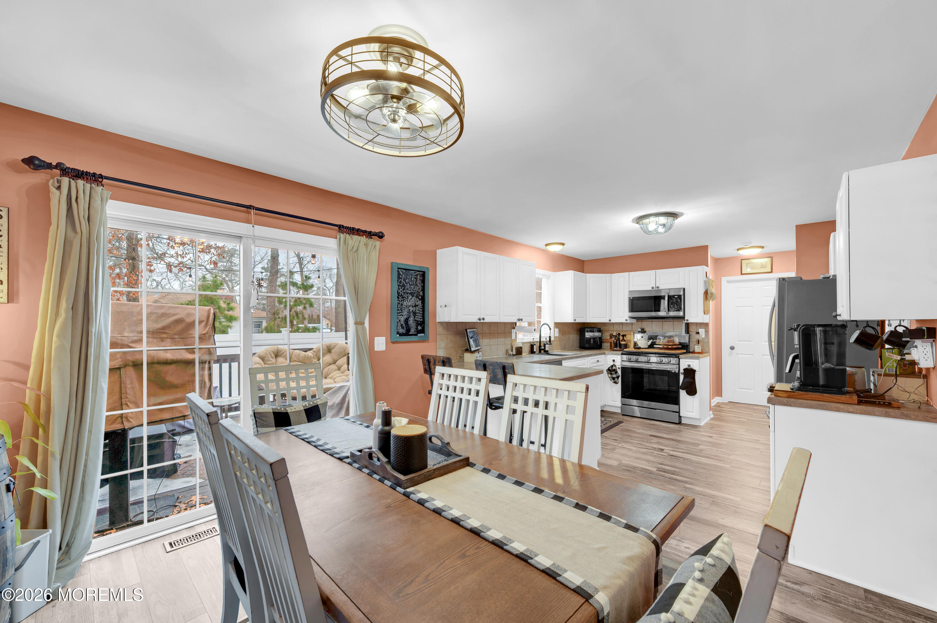 321 Letts Avenue Forked River, NJ 08731 - Photo 34 of 38 a view of a dining room with furniture a kitchen and chandelier
