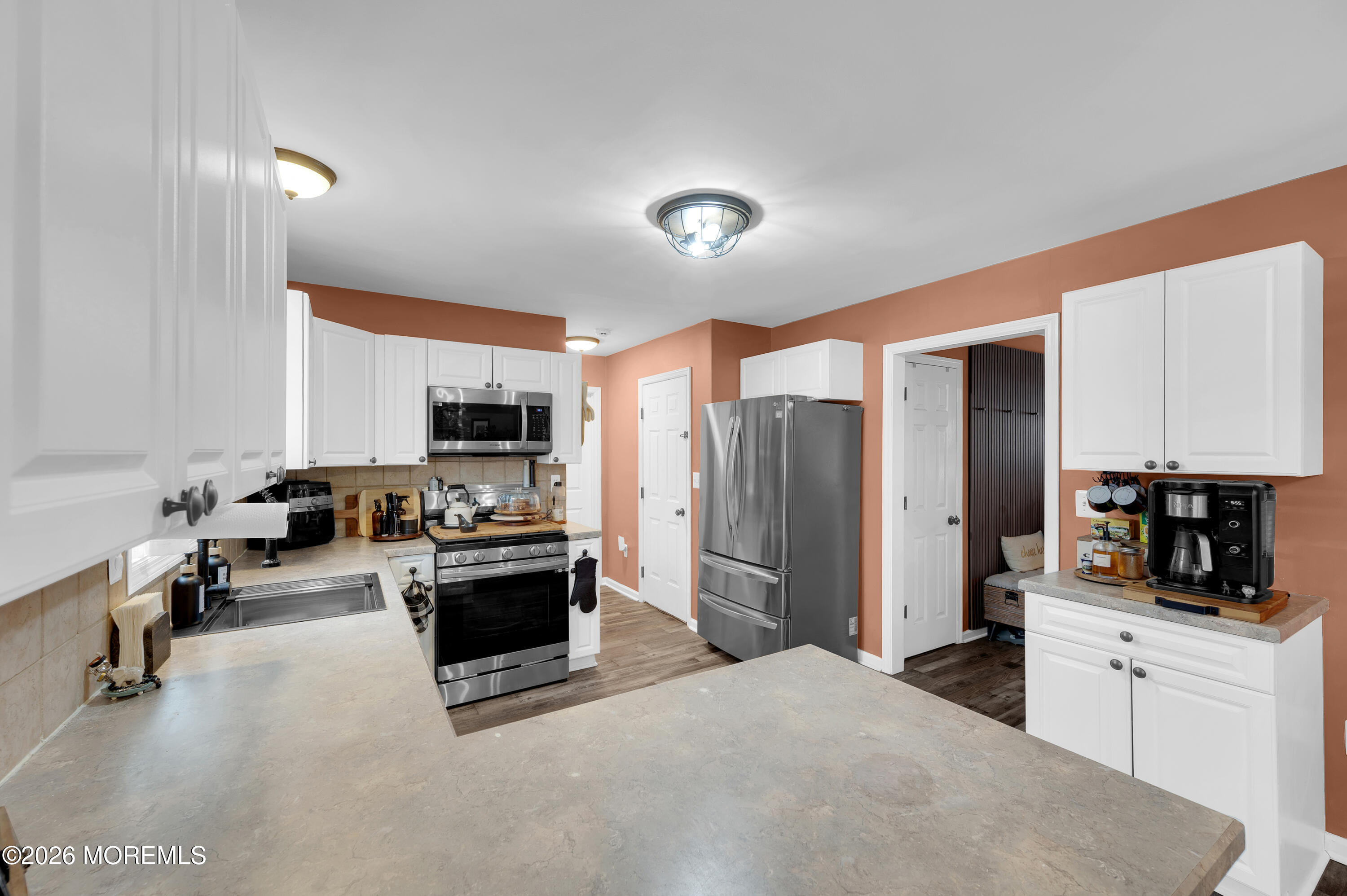 321 Letts Avenue Forked River, NJ 08731 - Photo 5 of 38 a kitchen with stainless steel appliances kitchen island granite countertop a refrigerator and stove top oven