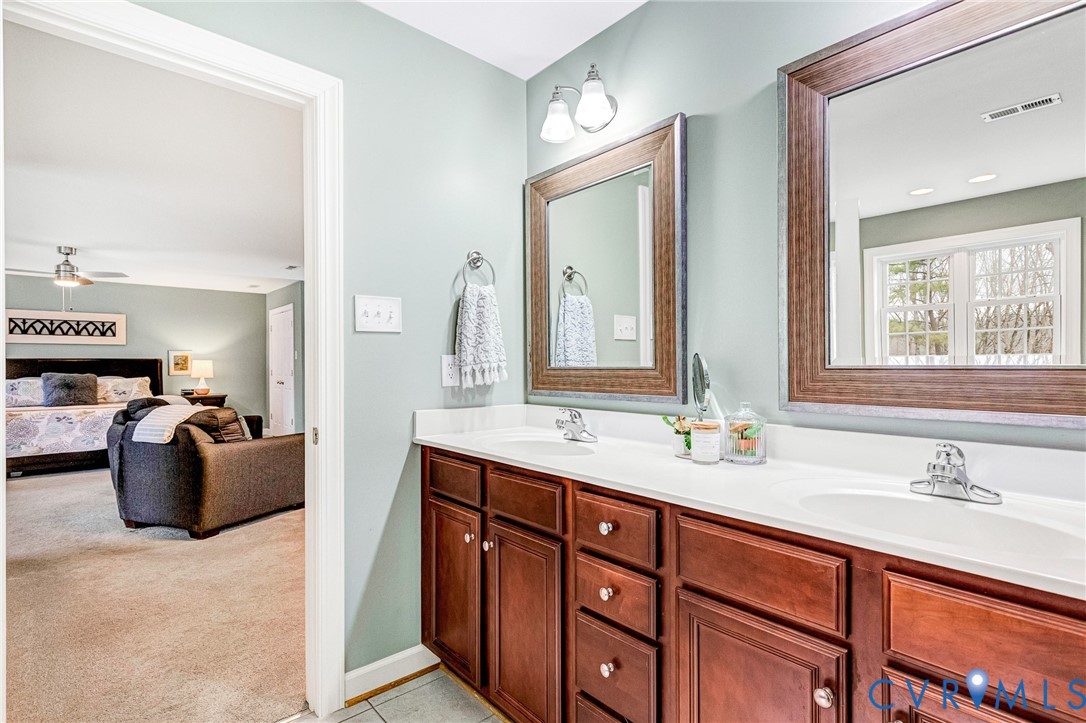 14436 Overlook Ridge Lane Beaverdam, VA 23015 - Photo 31 of 82 a en suite bathroom with double vanity and a mirror
