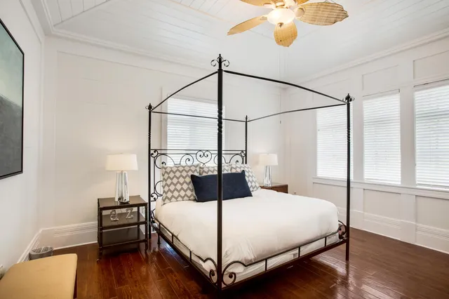 a bedroom with a bed and wooden floor