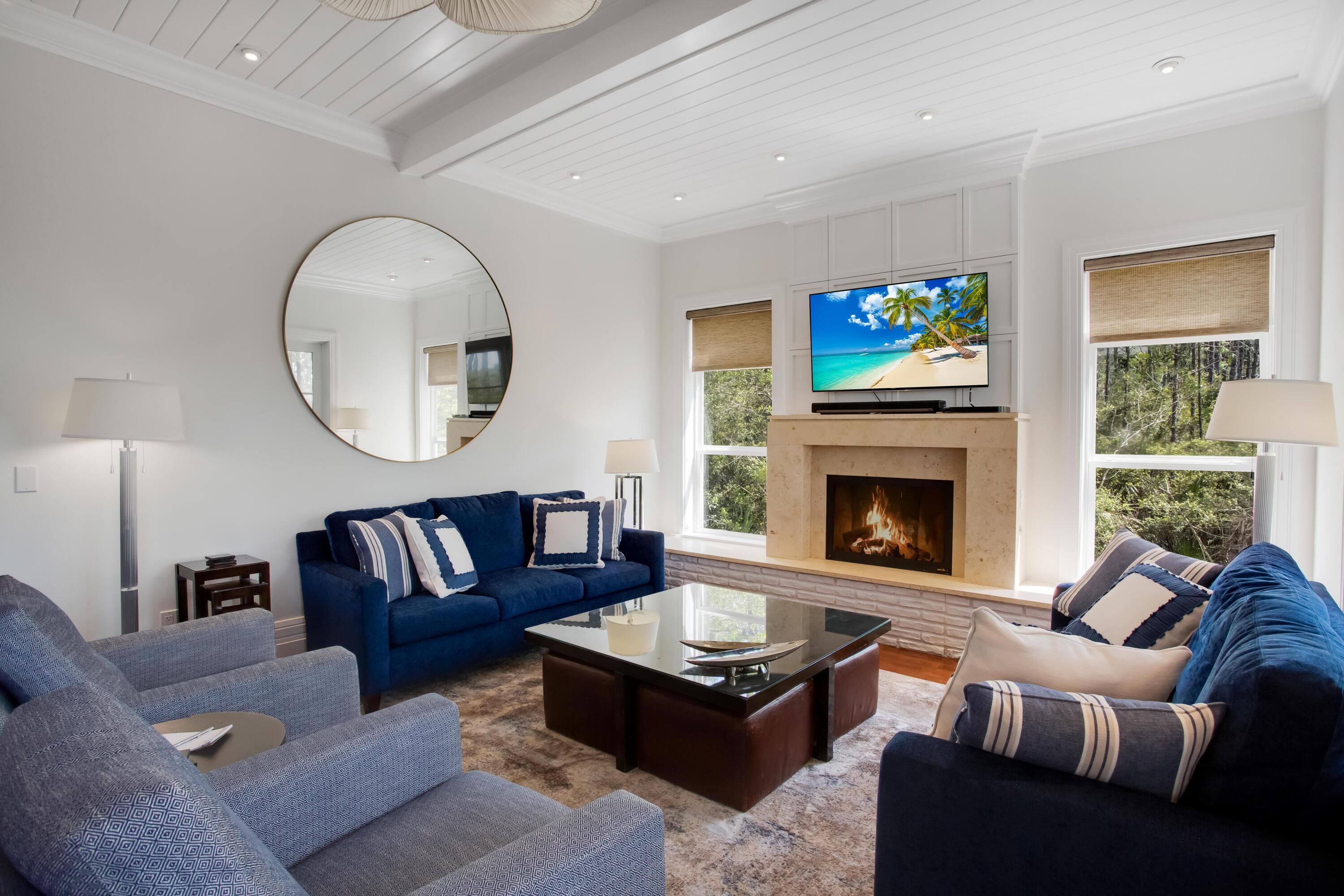 8103 Inspiration Drive, Unit E1 Miramar Beach, FL 32550 - Photo 6 of 42 a living room with furniture a fireplace and a large mirror