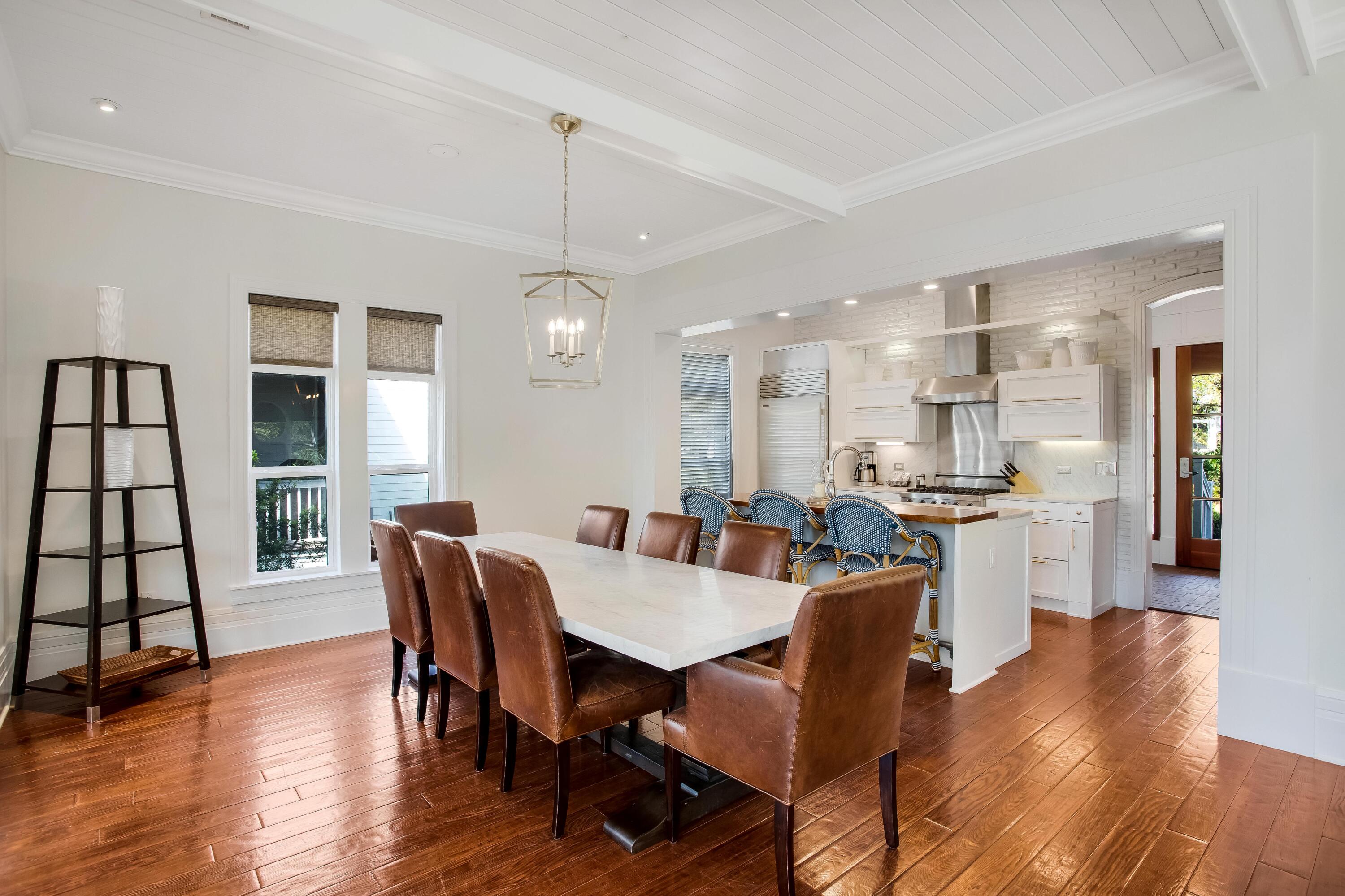 8103 Inspiration Drive, Unit E1 Miramar Beach, FL 32550 - Photo 7 of 42 a view of a dining room with furniture window and wooden floor