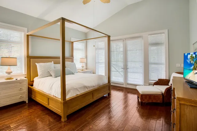 a large bed sitting in a bedroom next to a window