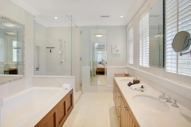 a bathroom with a tub sink and mirror