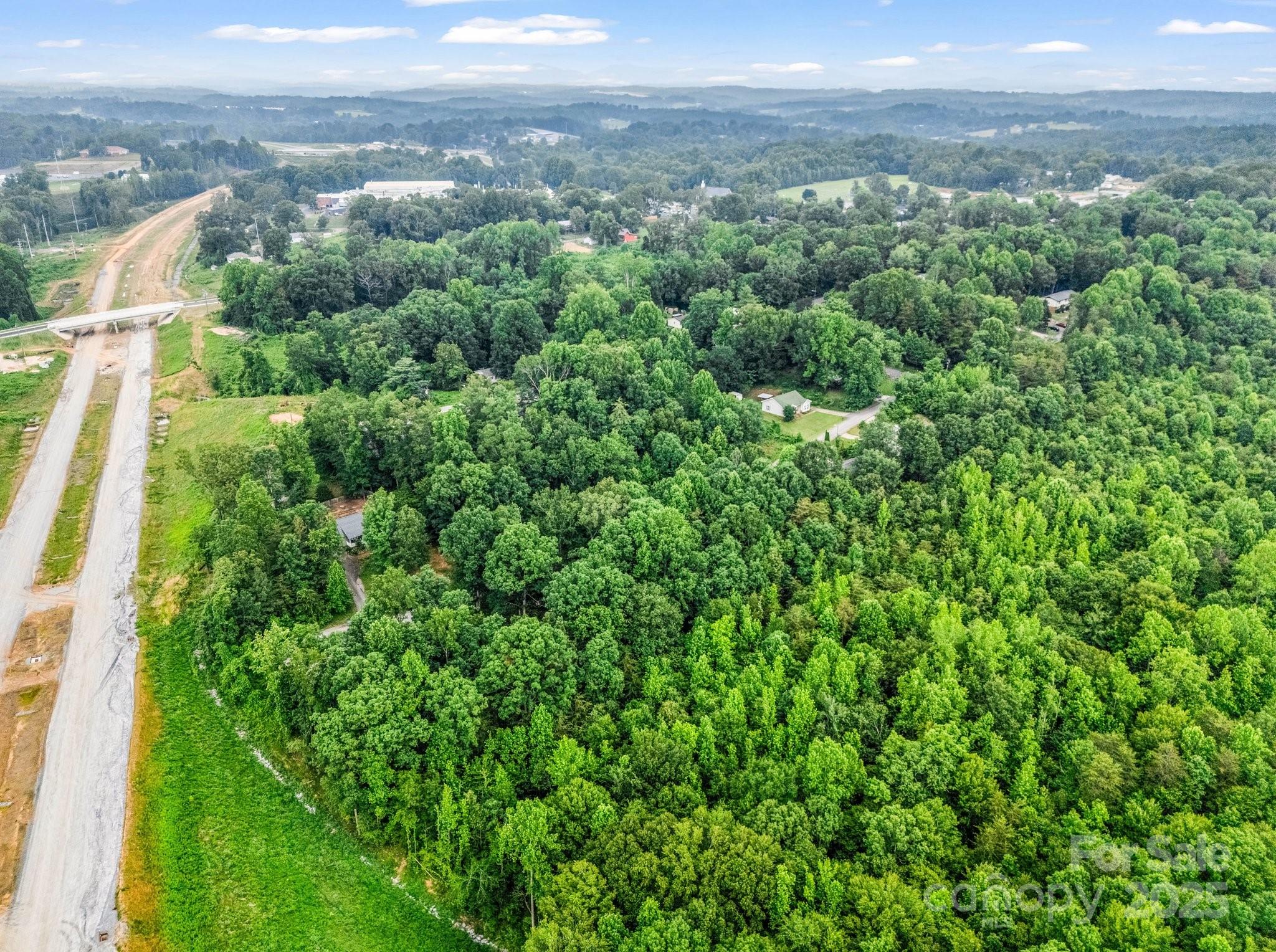 0 Hutchins Drive, Unit 14 15 Rutherfordton, NC 28139 - Photo 7 of 26 a view of a city with lush green forest
