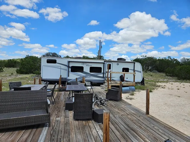 a view of a patio with chair and tables