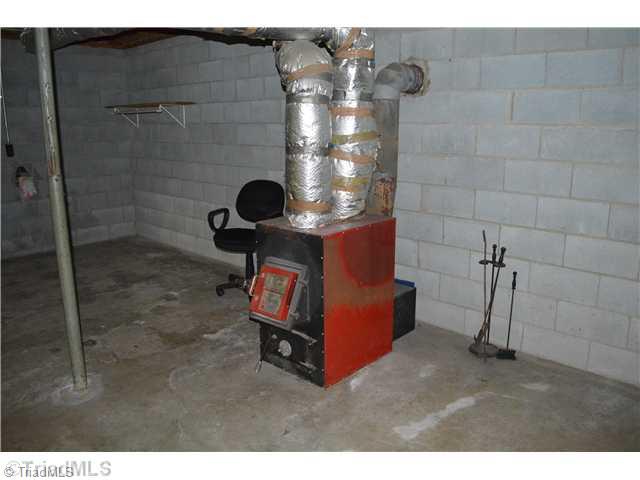 411 Turkey Ford Road Dobson, NC 27017 - Photo 16 of 16 Other. Woodburner in Basement!