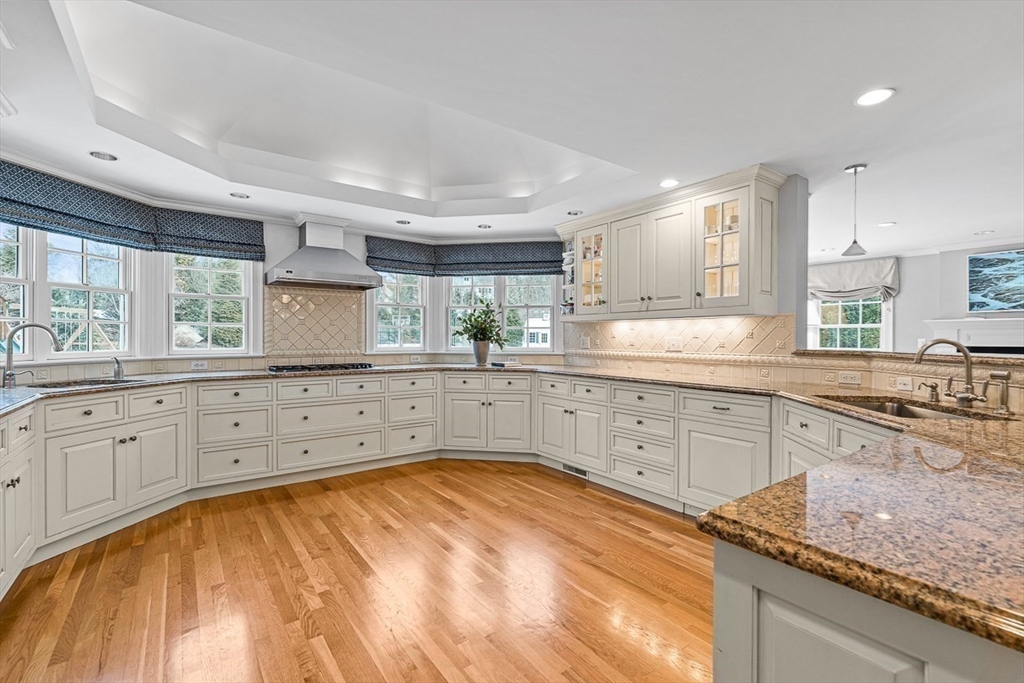169 Hampshire Road Wellesley, MA 02481 - Photo 11 of 42 a kitchen with granite countertop white cabinets white appliances a sink and a window