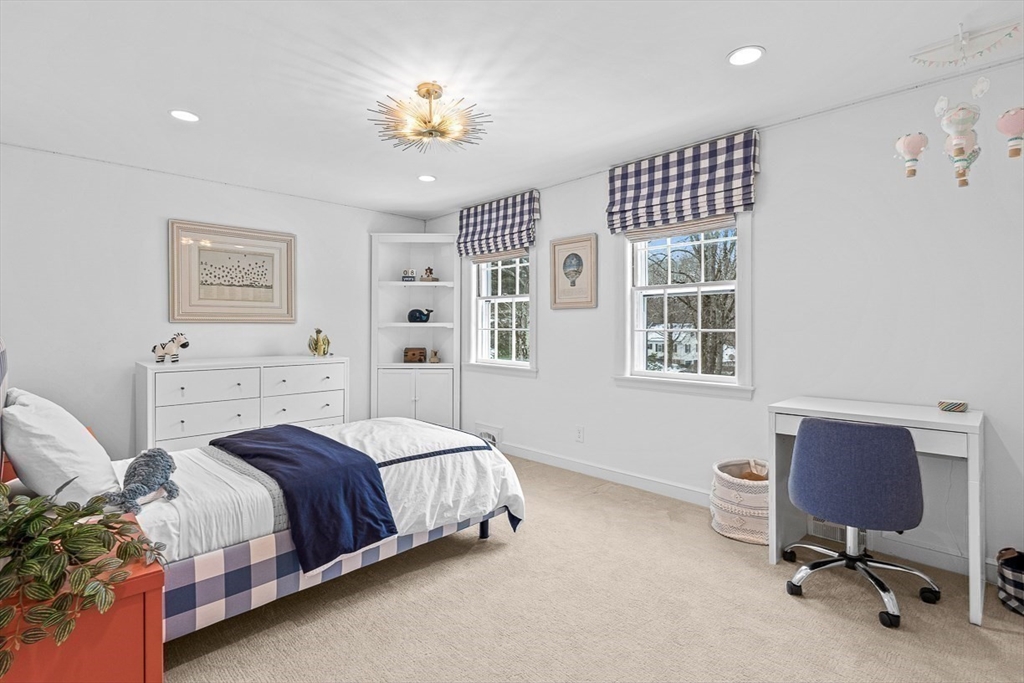 169 Hampshire Road Wellesley, MA 02481 - Photo 30 of 42 a bedroom with a bed and a chandelier