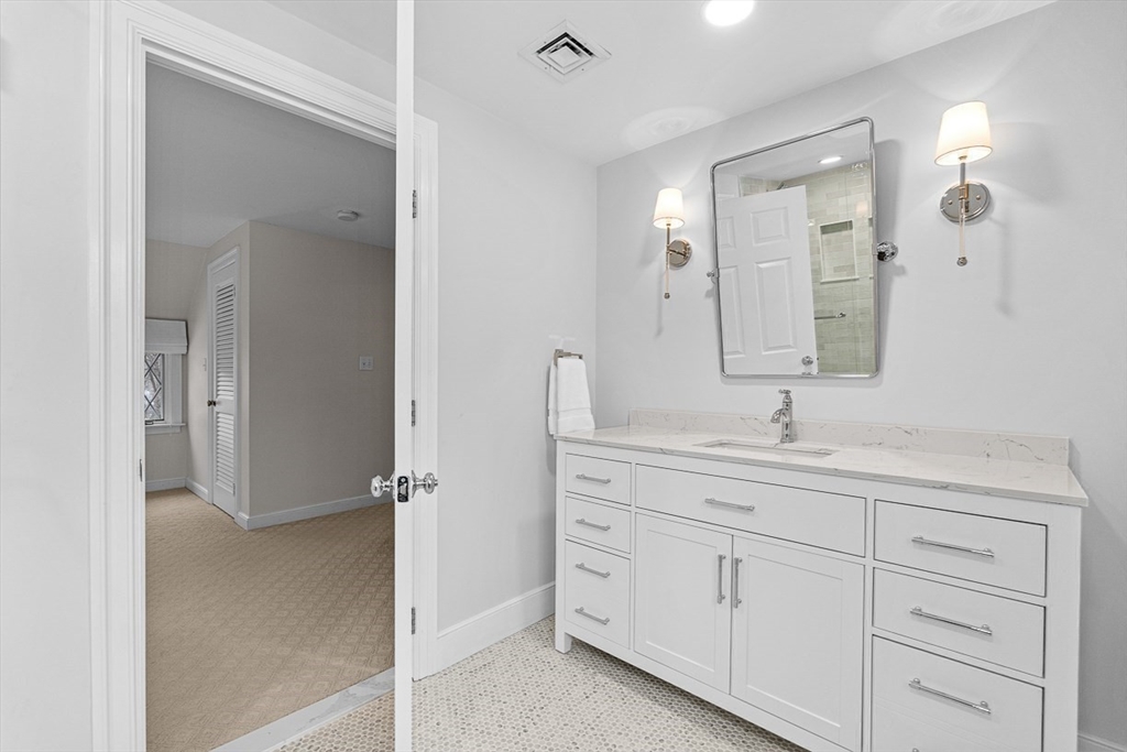 169 Hampshire Road Wellesley, MA 02481 - Photo 36 of 42 a bathroom with a granite countertop sink mirror and double