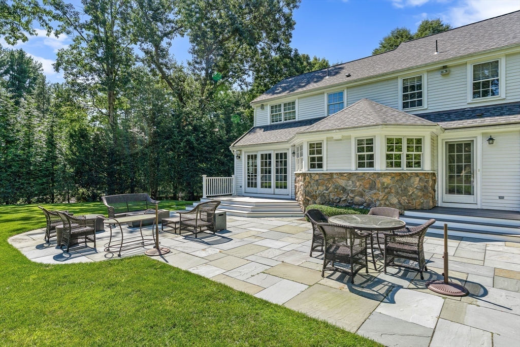 169 Hampshire Road Wellesley, MA 02481 - Photo 38 of 42 a view of a house with backyard sitting area and garden