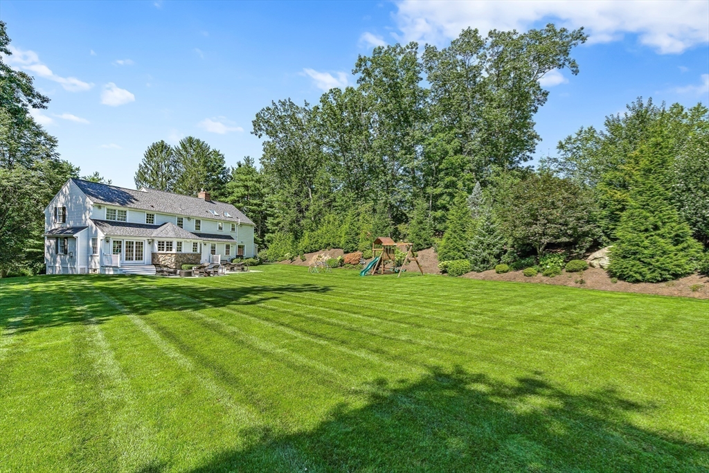 169 Hampshire Road Wellesley, MA 02481 - Photo 42 of 42 a view of a big house with a big yard and large trees