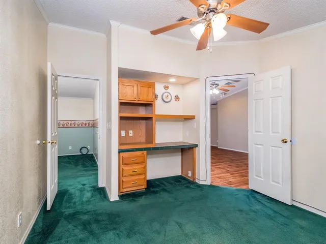 a view of a room with window and ceiling fan