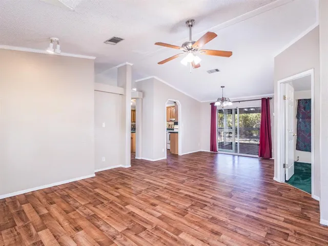 a view of an empty room with a fireplace and a window