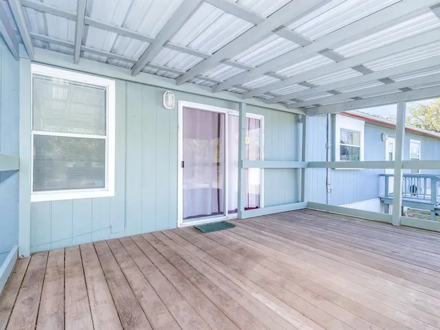 a view of a house with backyard and a tree