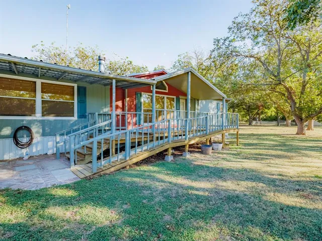 a view of a house with a yard and deck