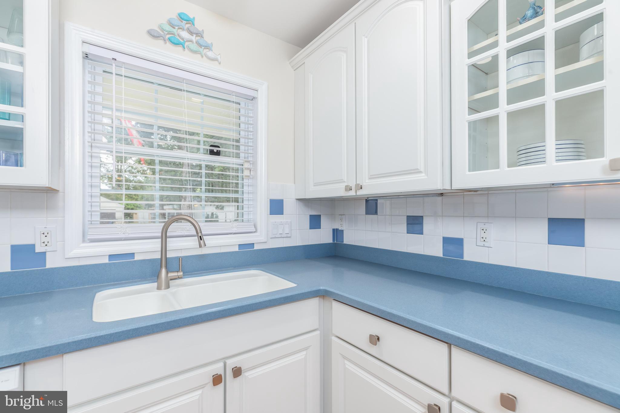28016 Possum Point Road Millsboro, DE 19966 - Photo 11 of 70 a kitchen with granite countertop a sink a window and cabinets