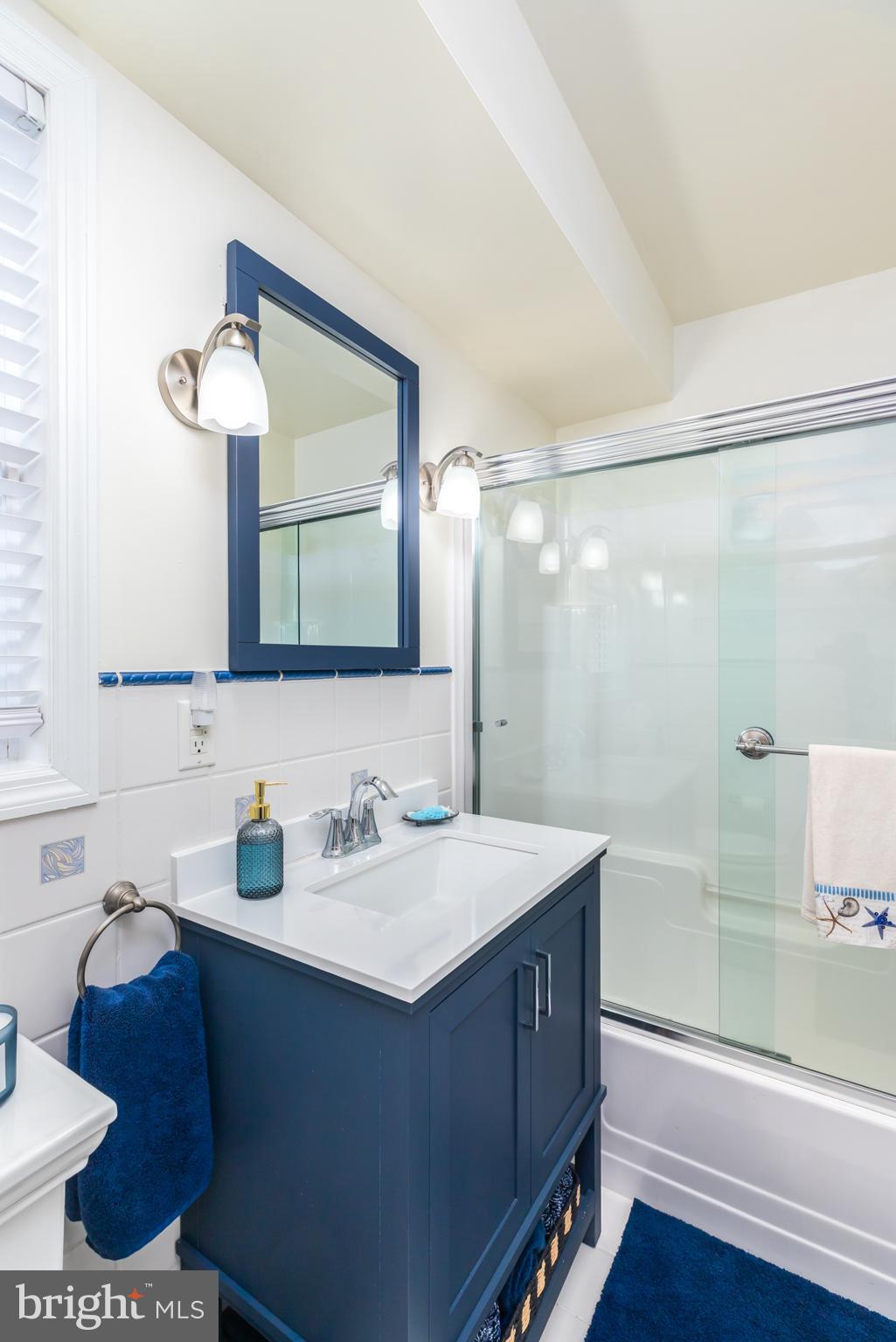 28016 Possum Point Road Millsboro, DE 19966 - Photo 13 of 70 a bathroom with a sink and a mirror
