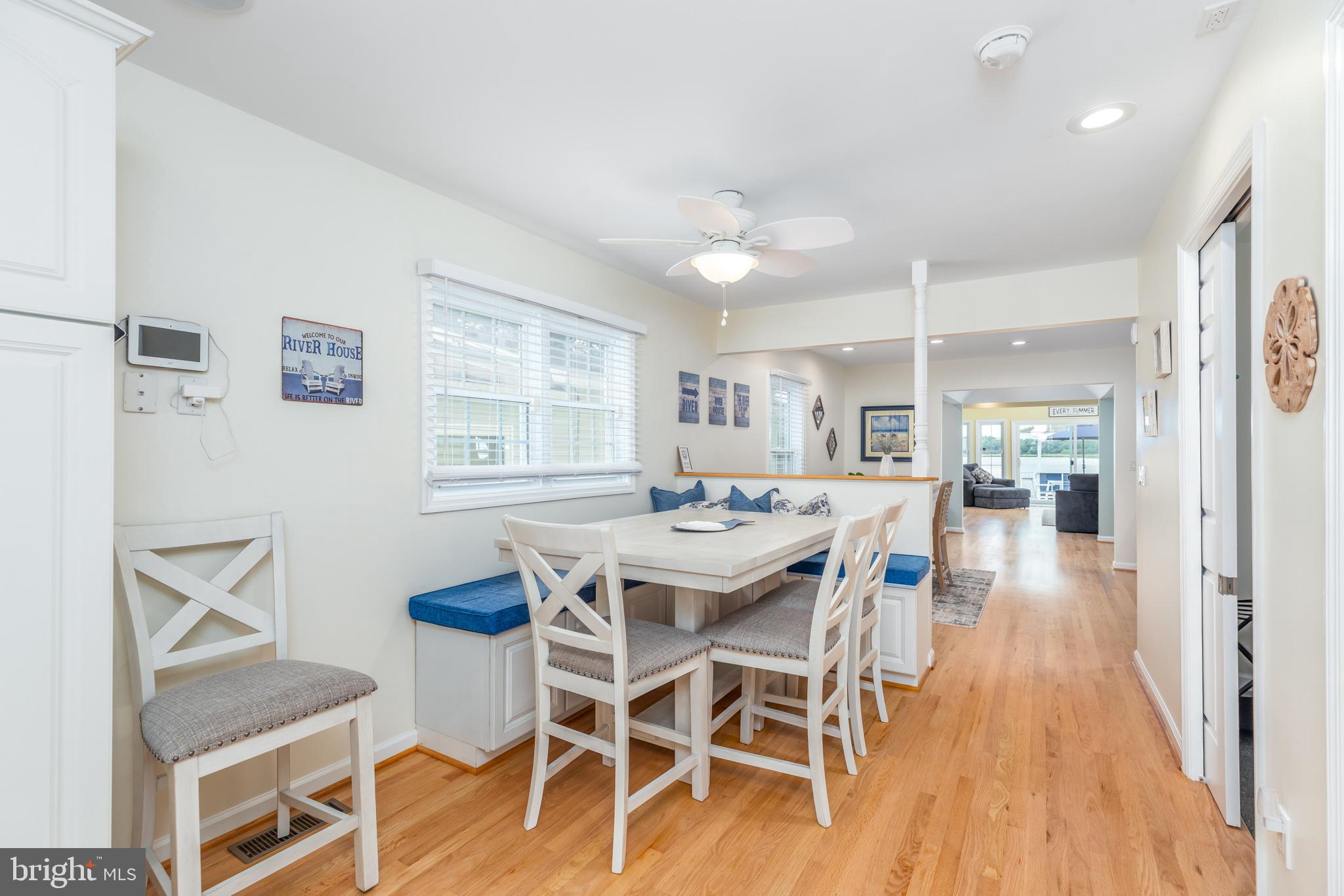 28016 Possum Point Road Millsboro, DE 19966 - Photo 16 of 70 a dining room with furniture and wooden floor