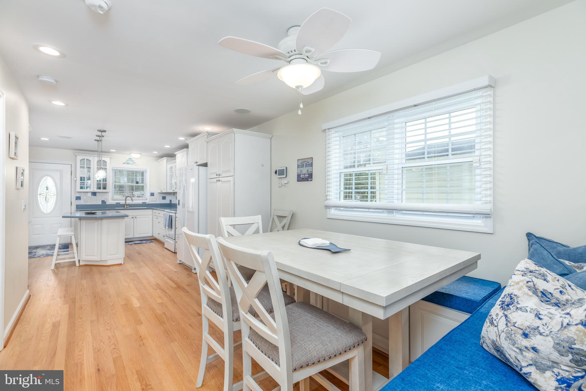 28016 Possum Point Road Millsboro, DE 19966 - Photo 17 of 70 a view of a dining room with furniture and wooden floor