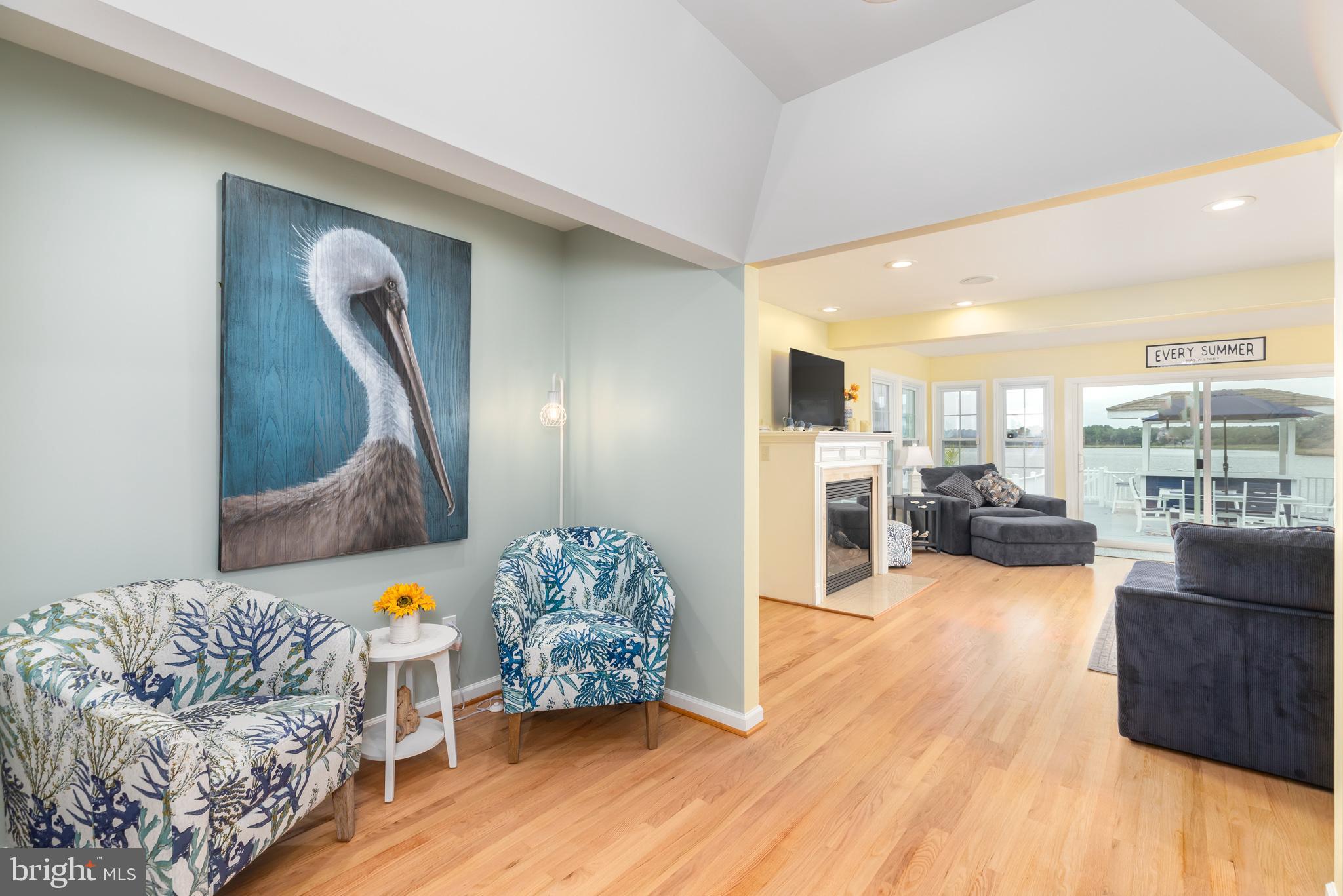 28016 Possum Point Road Millsboro, DE 19966 - Photo 23 of 70 a living room with furniture and a wooden floor