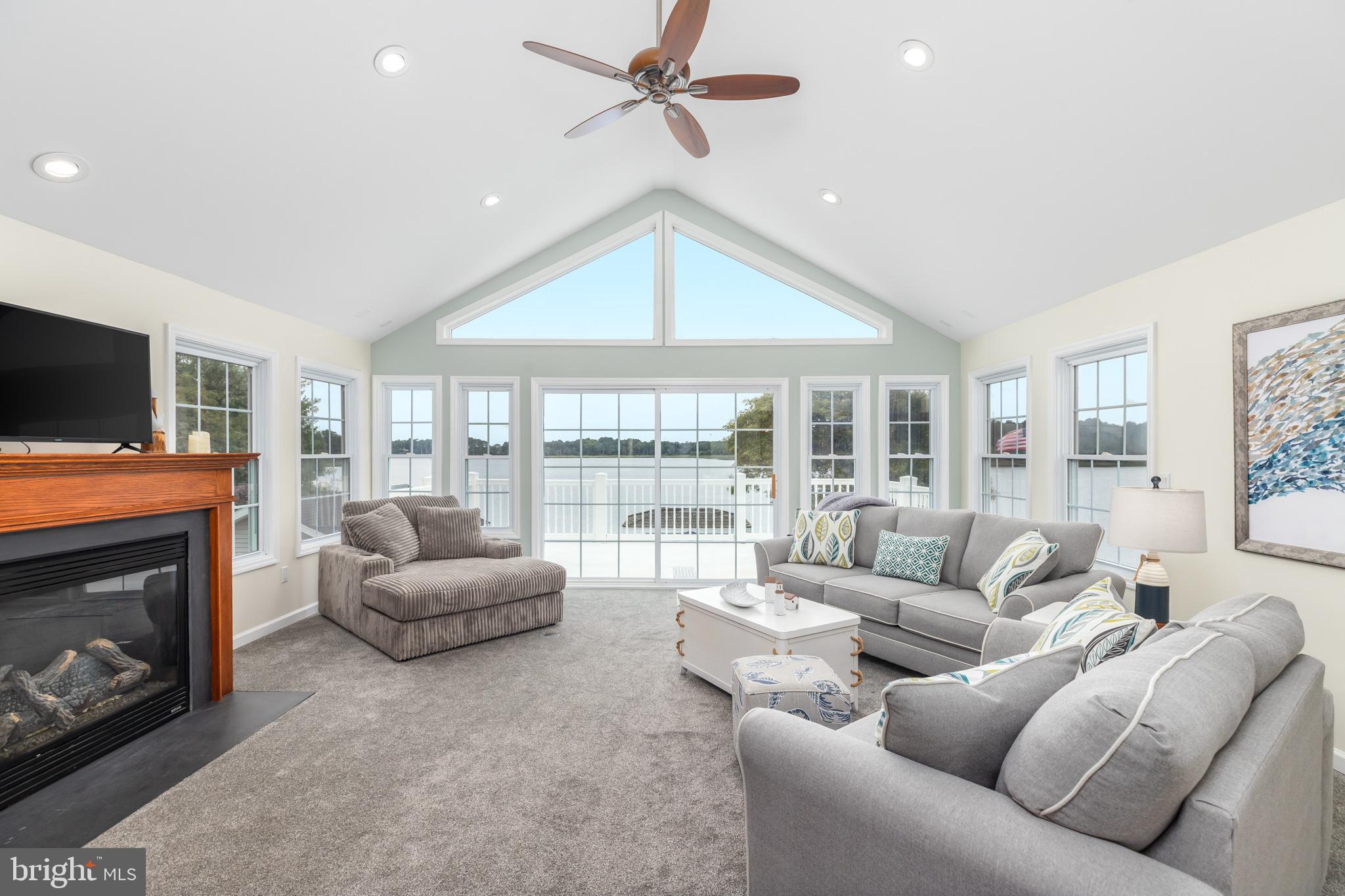 28016 Possum Point Road Millsboro, DE 19966 - Photo 29 of 70 a living room with furniture a flat screen tv and a fireplace