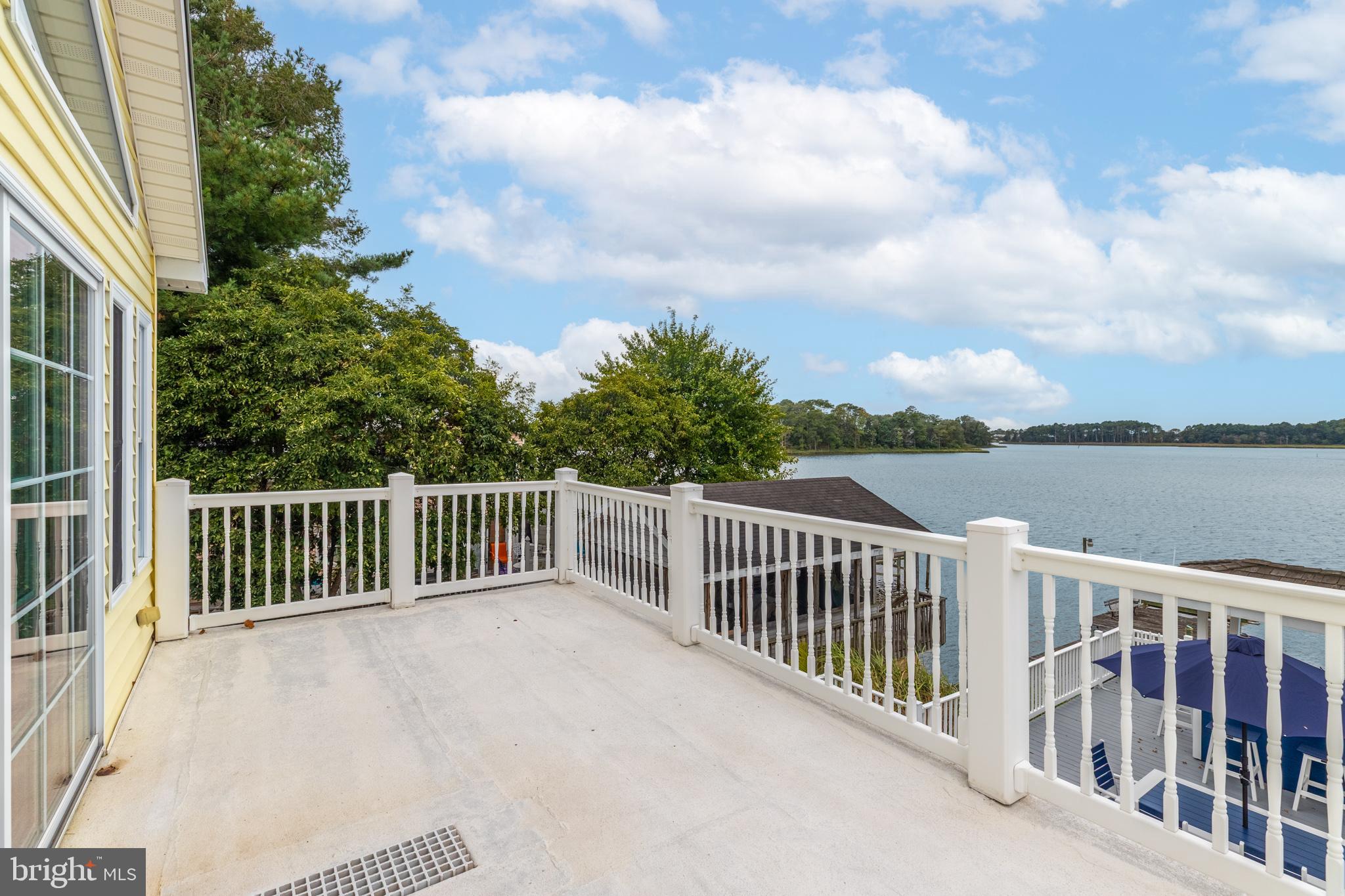 28016 Possum Point Road Millsboro, DE 19966 - Photo 32 of 70 a balcony with wooden floor and fence and trees