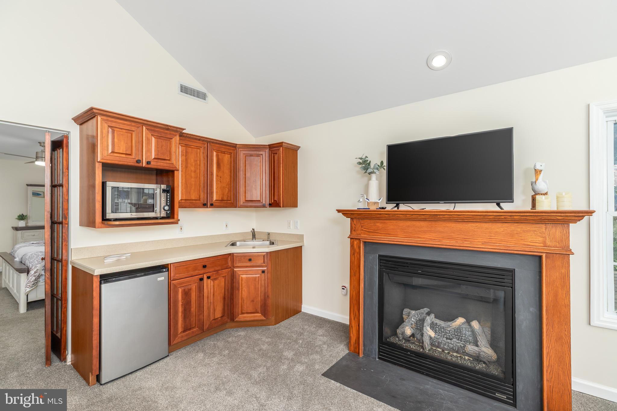 28016 Possum Point Road Millsboro, DE 19966 - Photo 35 of 70 a living room with a fireplace and a television