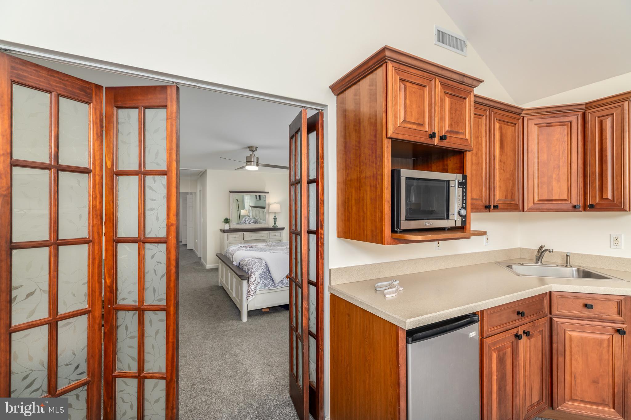 28016 Possum Point Road Millsboro, DE 19966 - Photo 36 of 70 a kitchen with stainless steel appliances granite countertop a refrigerator and a sink
